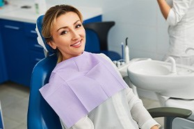 Woman smiling while sitting in treatment chair