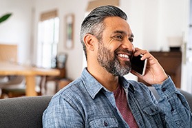 a denture patient talking on the phone