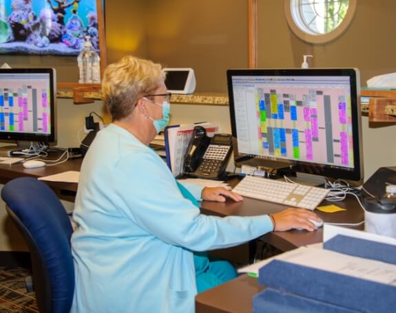 Dental team member using scheduling system on computer