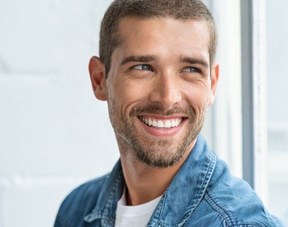 Man with flawless smile after metal free dental restorations