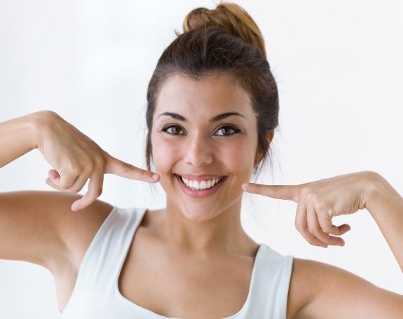 Woman pointing to smile after smile makeover