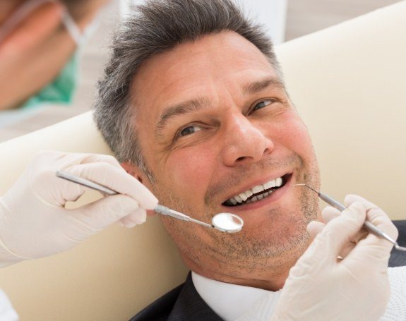 Patient receiving a dental exam to prevent emergencies