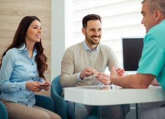 Two dental patients in a consultation with their dentist