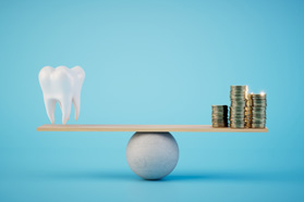 a model of a tooth and a stack of coins