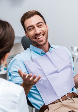 Man smiling at dentist during preventive dentistry visit