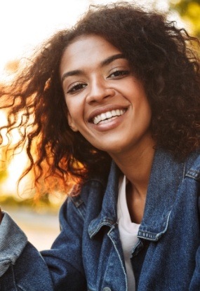 Woman with beautiful smile after Invisalign clear braces treatment