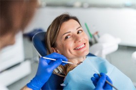 Woman smiling at dentist during dental checkup