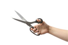 Closeup of patient holding scissors