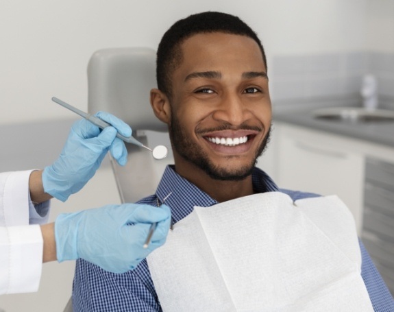 Man smiling during dental checkup and teeth cleaning visit