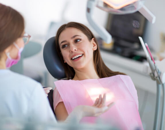 Patient talking to dentist after fluoride treatment