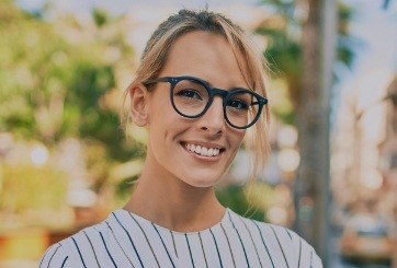 Woman smiling after emergency dentistry visit