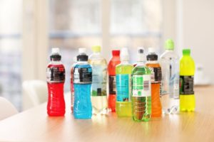 various sports drinks on wooden table