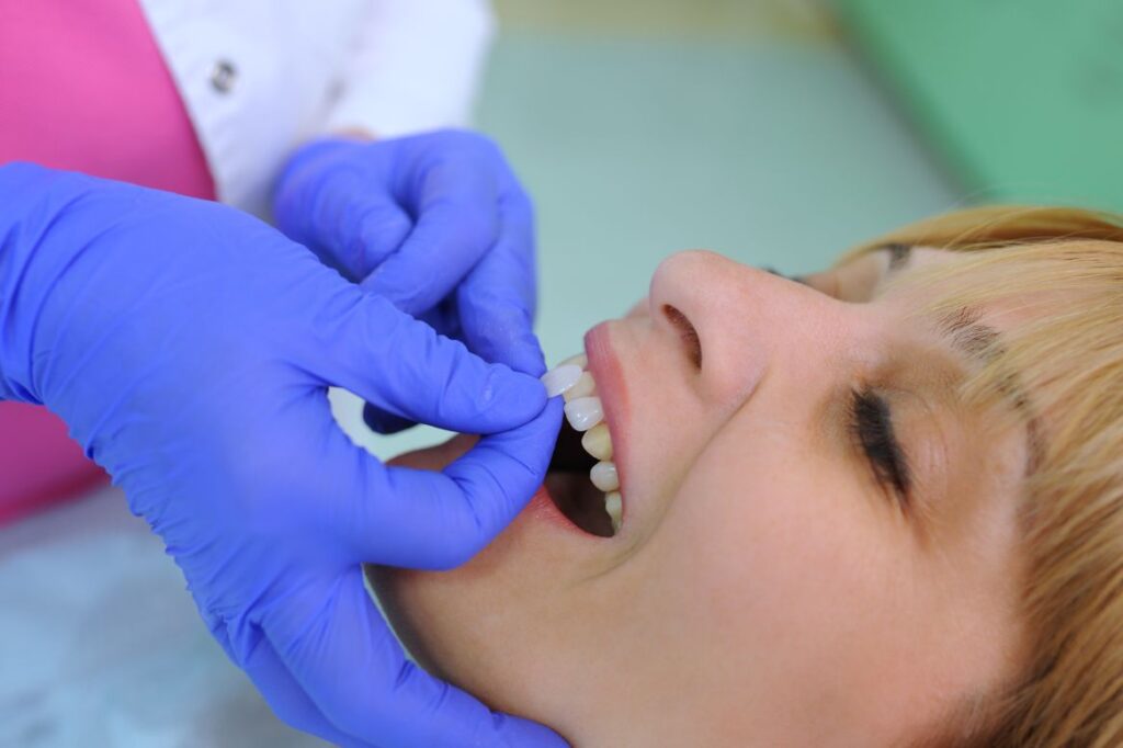 A woman getting temporary veneers from her dentist