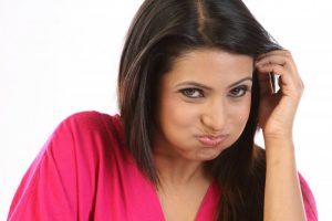 A woman swishing her mouth with oil.