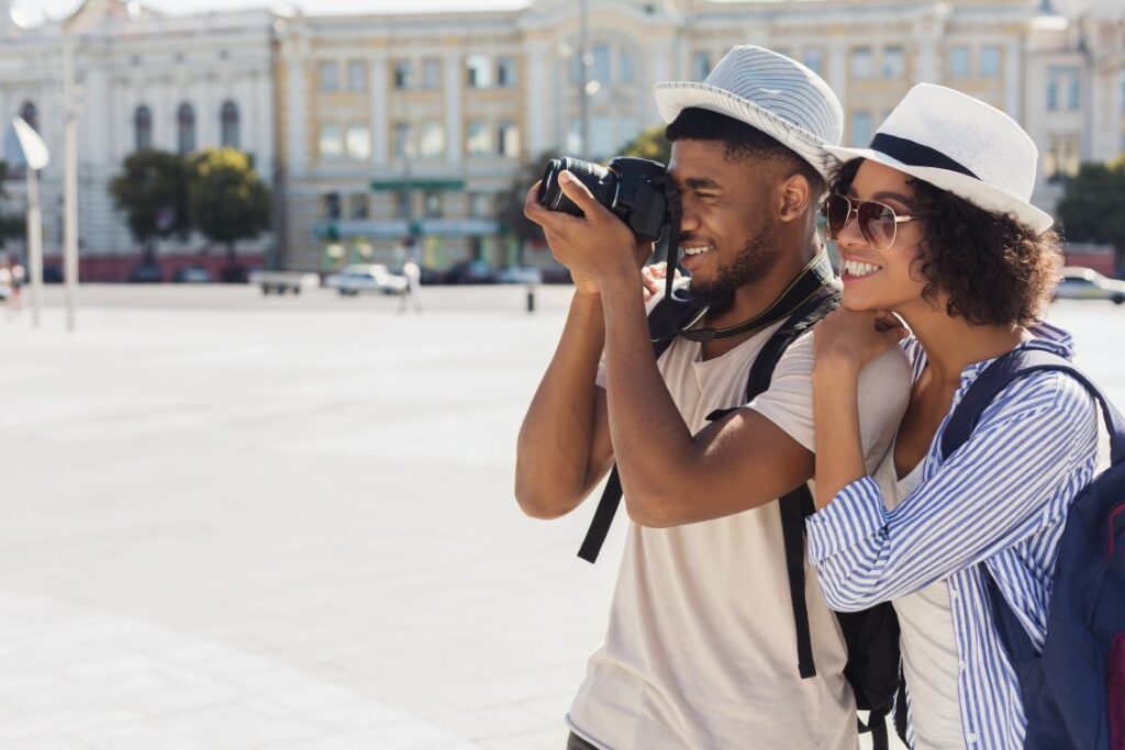 A man and woman taking vacation photos