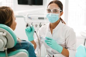 Dentist pausing from work to smile for camera. 