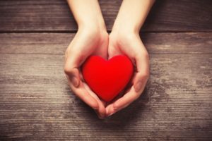 Cupped hands holding heart shape untouched by gum disease