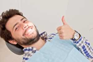 man dental chair smiling thumb up