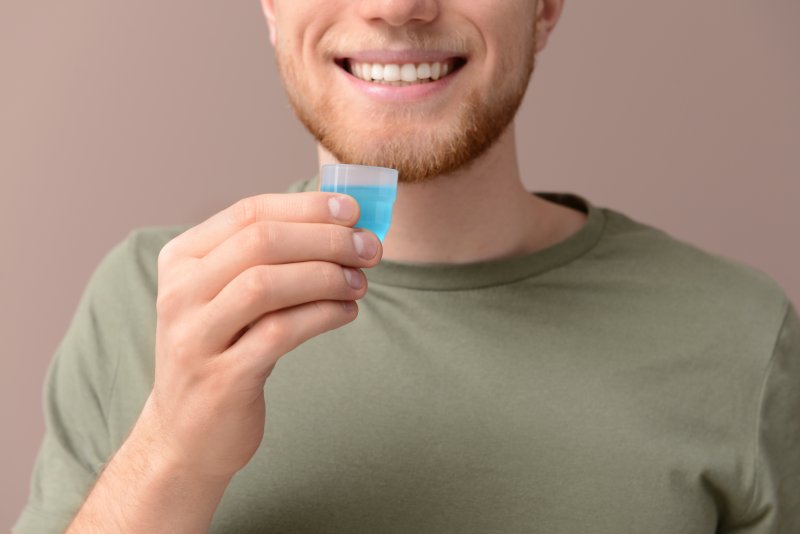 Man using mouthwash