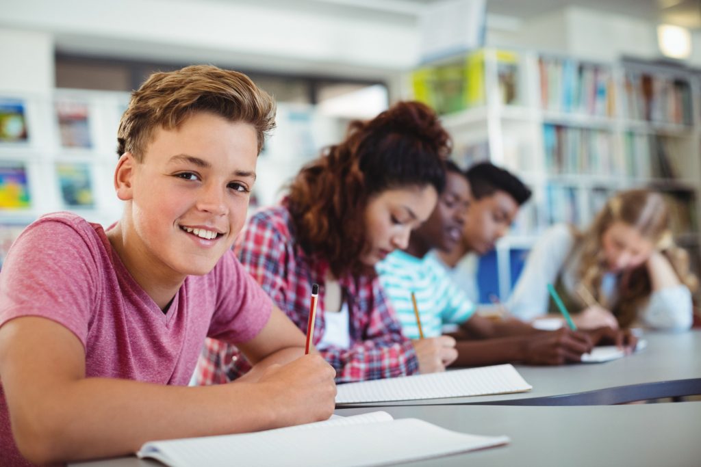 Child smiling while working in classroom