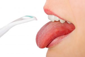 woman mouth open tongue scraper