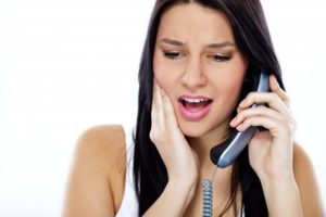 woman with dental emergency calling local dentist